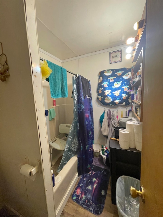 bathroom with toilet, shower / bath combo with shower curtain, and hardwood / wood-style flooring