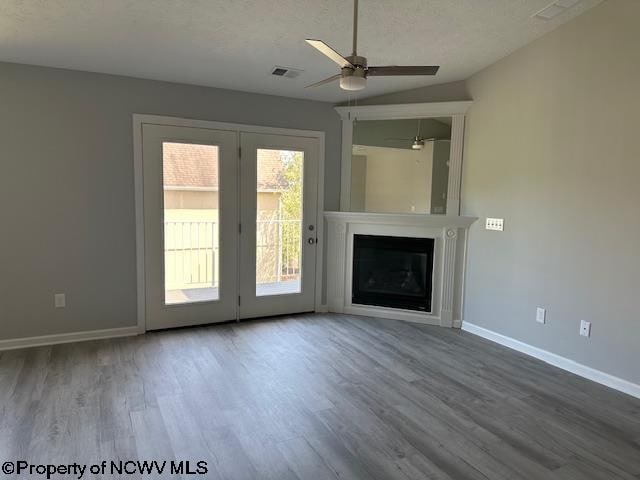 unfurnished living room featuring ceiling fan and wood-type flooring