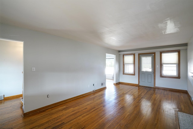 empty room with dark hardwood / wood-style flooring