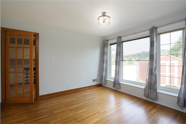 spare room with hardwood / wood-style flooring