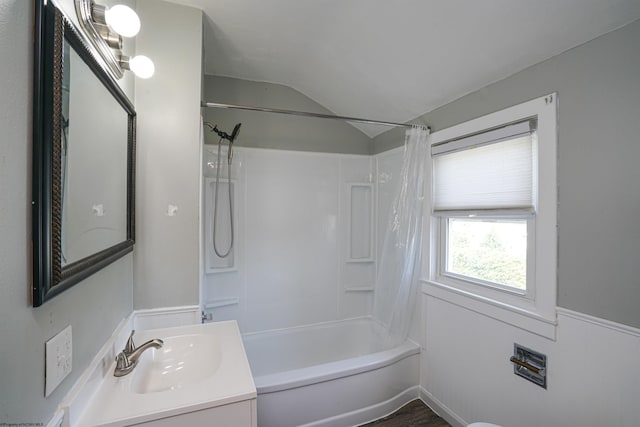 bathroom with vanity, lofted ceiling, and shower / tub combo with curtain