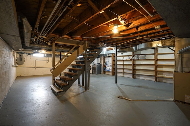 basement featuring electric panel and washer / clothes dryer