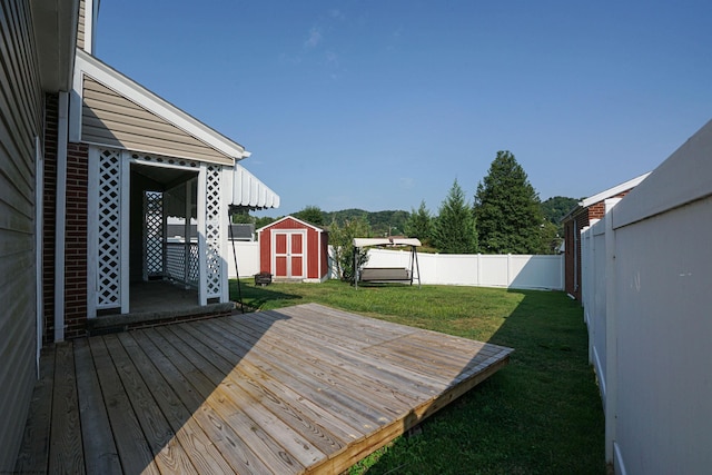 wooden terrace with a yard and a shed