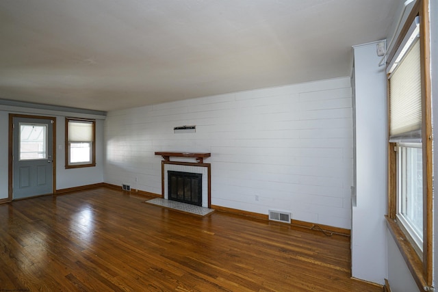 unfurnished living room with a fireplace and dark hardwood / wood-style floors