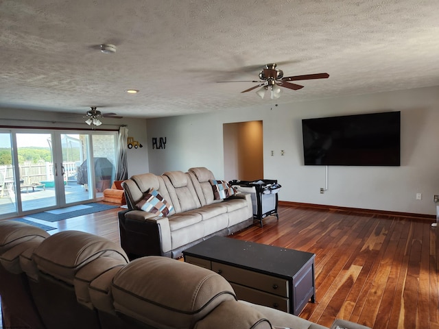 living room featuring ceiling fan, french doors, wood-type flooring, and a textured ceiling