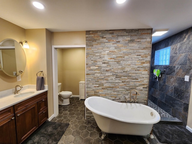 bathroom featuring vanity, tile patterned flooring, toilet, and a tub