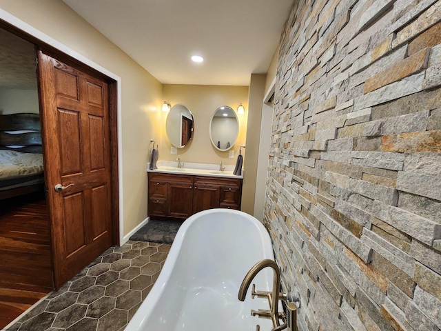 bathroom with vanity and a tub to relax in