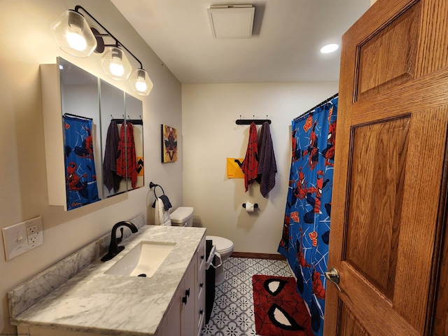 bathroom with toilet, vanity, and walk in shower