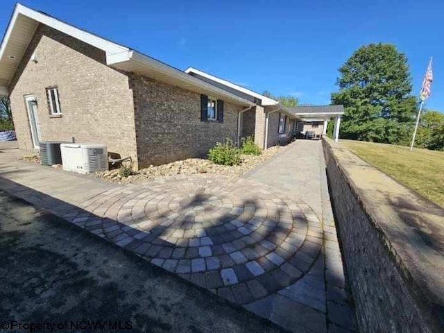 view of property exterior with central AC unit