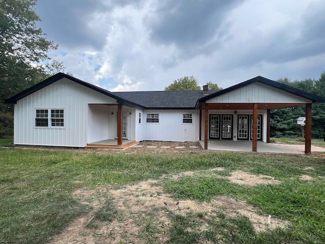 view of front of property with a front yard and french doors