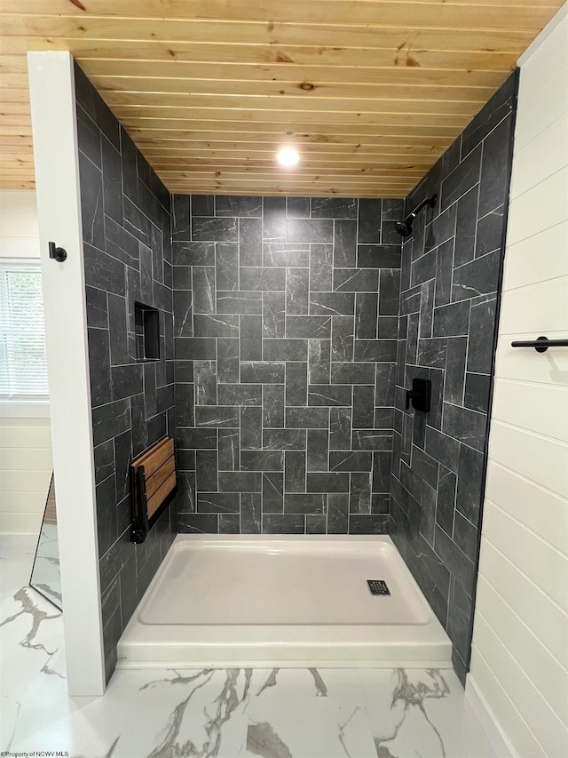 bathroom with wooden ceiling and a tile shower