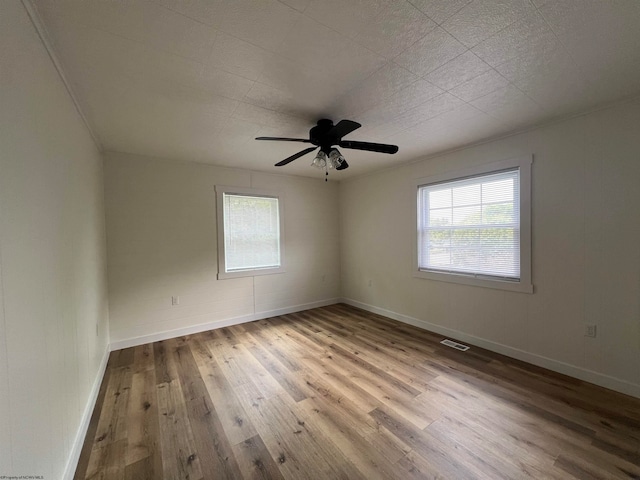 spare room featuring light hardwood / wood-style flooring and ceiling fan