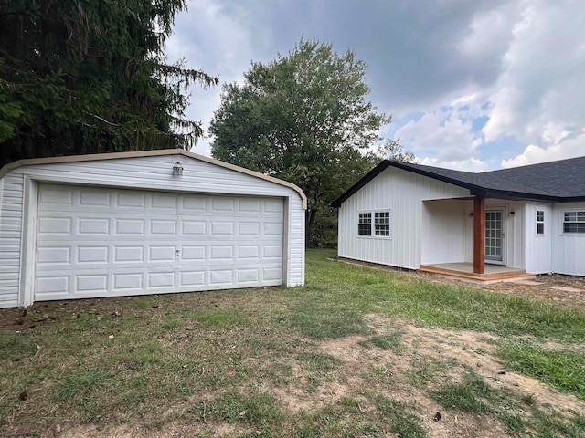 garage featuring a lawn