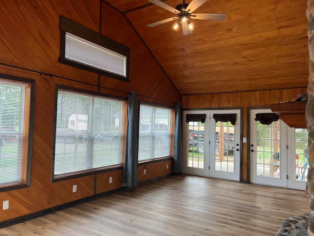 unfurnished sunroom featuring ceiling fan, plenty of natural light, and vaulted ceiling