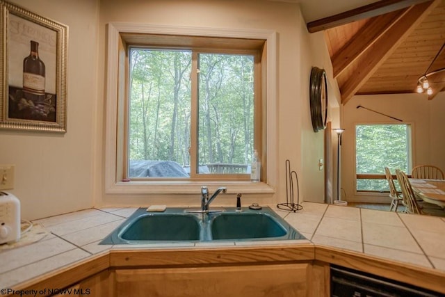 kitchen featuring tile counters, a wealth of natural light, sink, and wooden ceiling