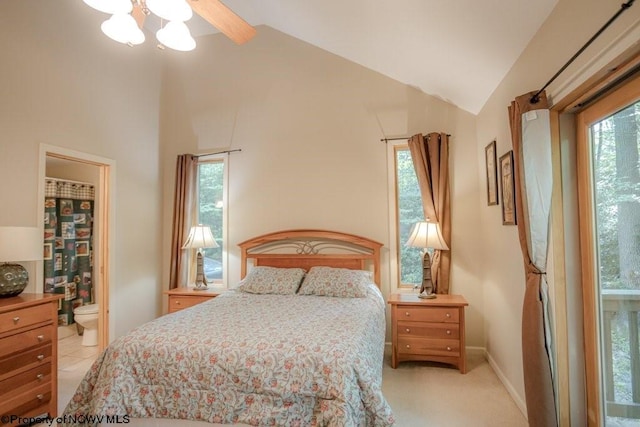 carpeted bedroom with ensuite bath, lofted ceiling, and ceiling fan