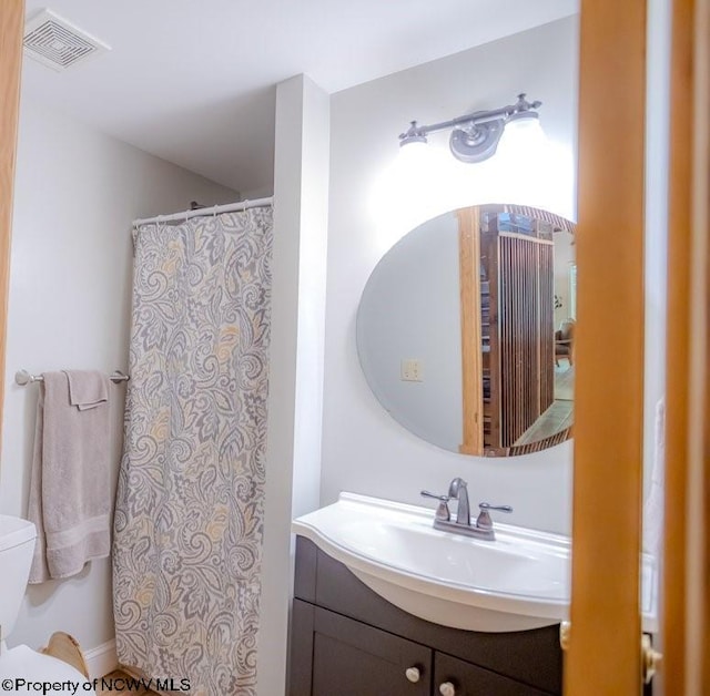 bathroom with toilet and vanity