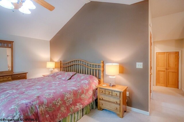 bedroom featuring high vaulted ceiling, ceiling fan, and light colored carpet