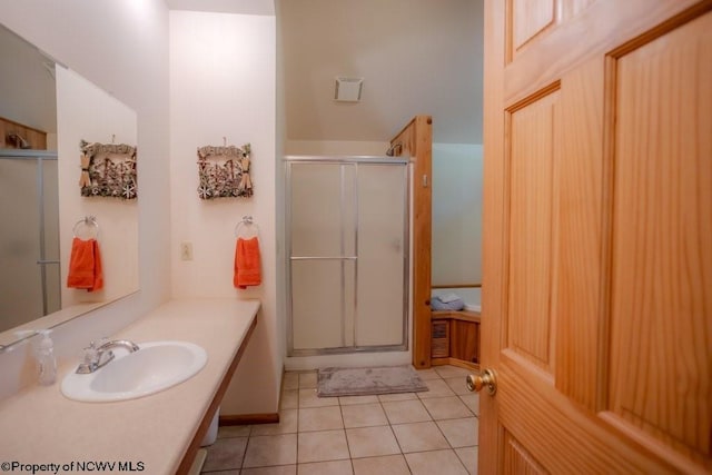 bathroom with vanity, an enclosed shower, and tile patterned floors