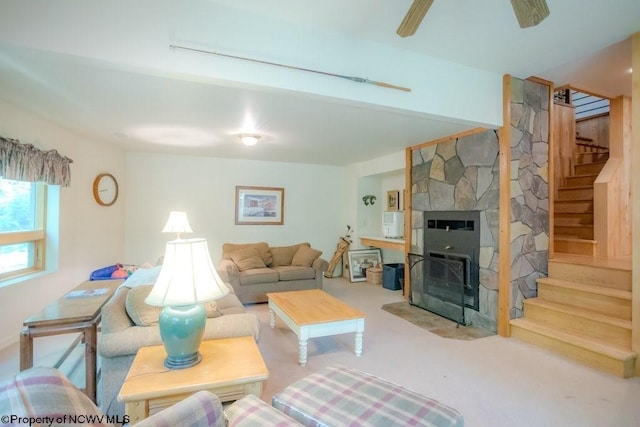 living room with ceiling fan and a fireplace