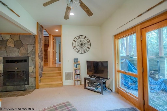 living room with ceiling fan and carpet