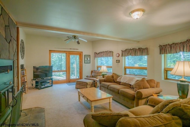 carpeted living room with ceiling fan and a fireplace