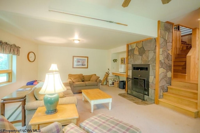 carpeted living room with ceiling fan, a fireplace, and heating unit