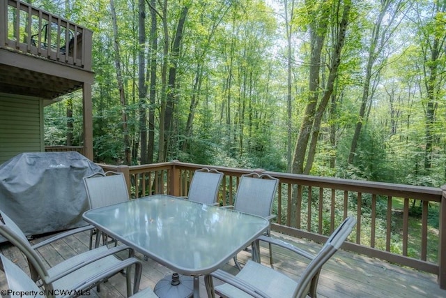 wooden deck featuring a grill