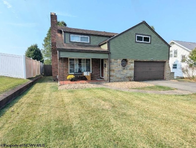 view of property featuring a garage, covered porch, and a front yard