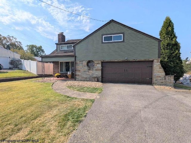 view of front of home with a front yard and a garage