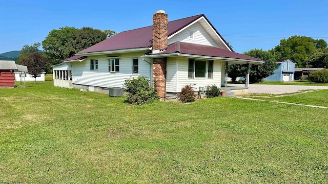 exterior space featuring a front yard and central AC unit