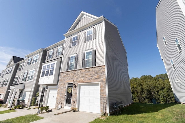 multi unit property featuring a garage and a front lawn