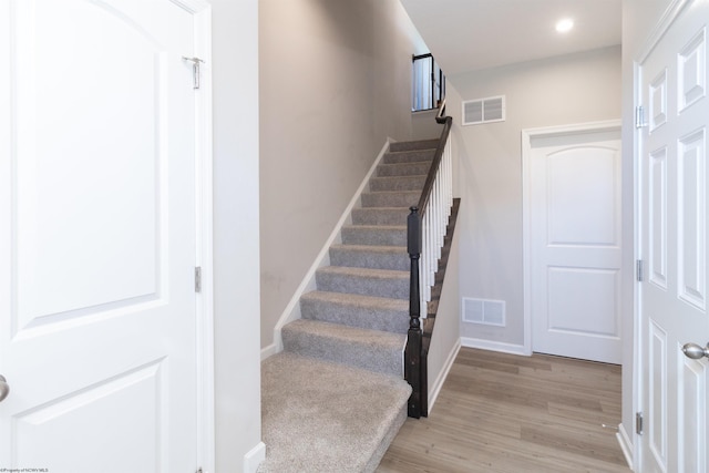 stairs with wood-type flooring