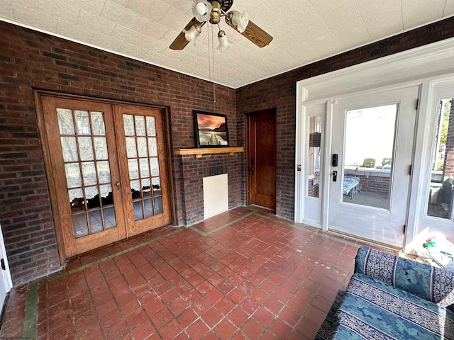 unfurnished sunroom with french doors and ceiling fan