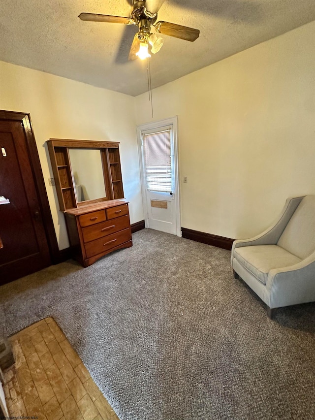 unfurnished room with carpet flooring, ceiling fan, and a textured ceiling