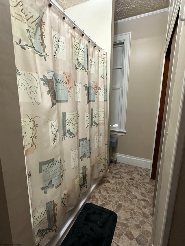 bathroom featuring a textured ceiling and crown molding