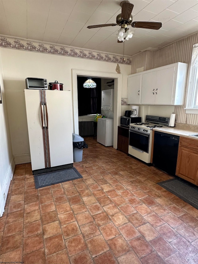 kitchen with white cabinets, white appliances, stacked washer / drying machine, and ceiling fan