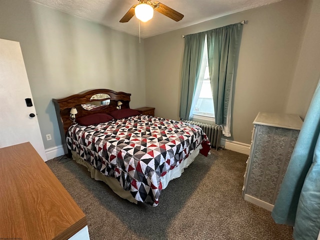 bedroom with ceiling fan, dark colored carpet, and radiator heating unit