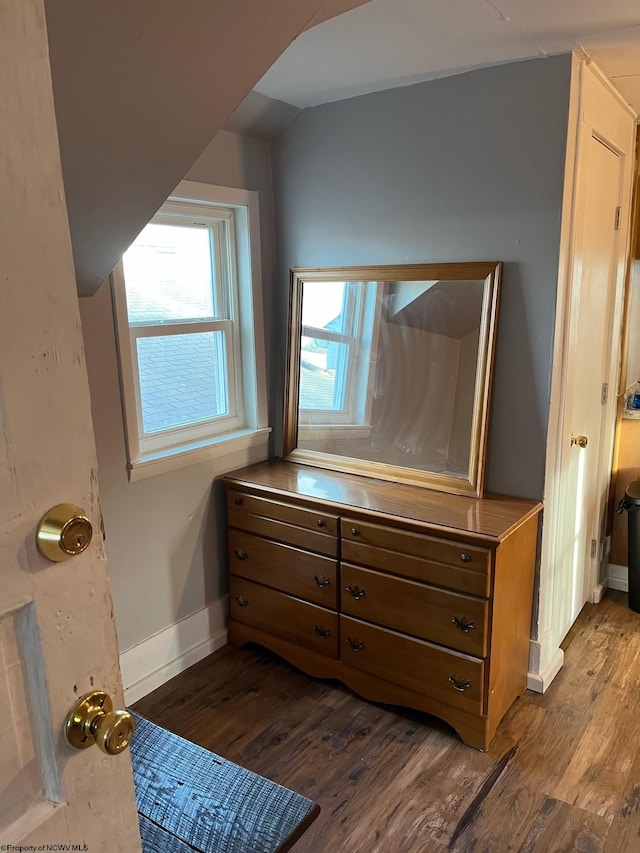 bedroom with vaulted ceiling and wood-type flooring