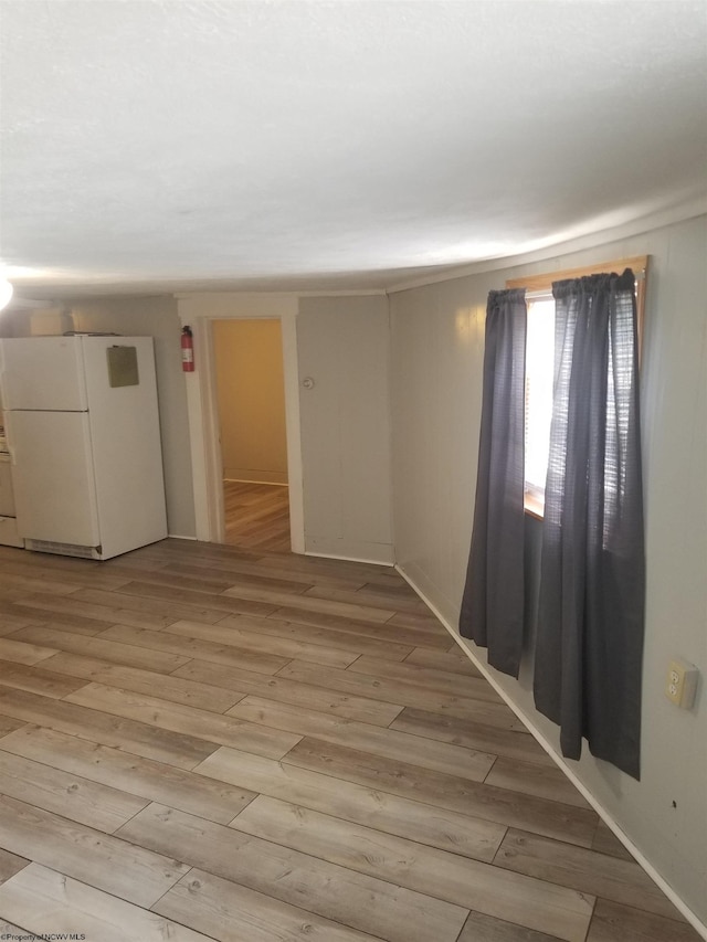 spare room with light wood-type flooring