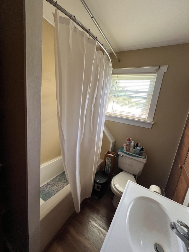 full bath featuring toilet, a sink, and wood finished floors