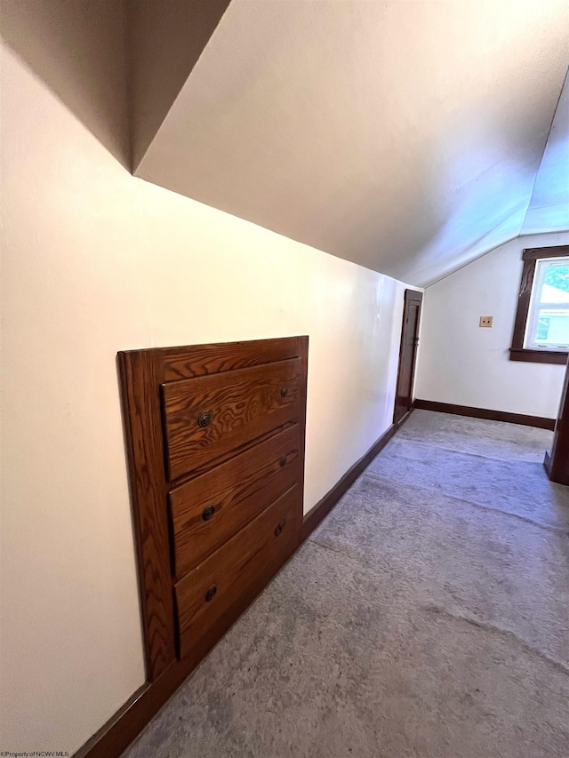 bonus room featuring carpet, baseboards, and vaulted ceiling