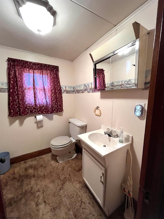 bathroom with toilet, baseboards, and vanity