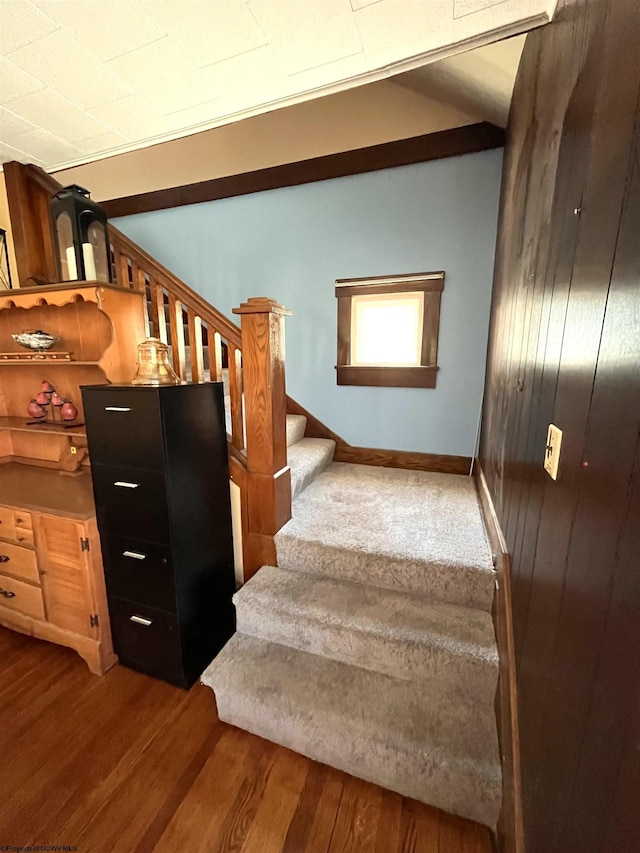 stairs featuring baseboards and wood finished floors