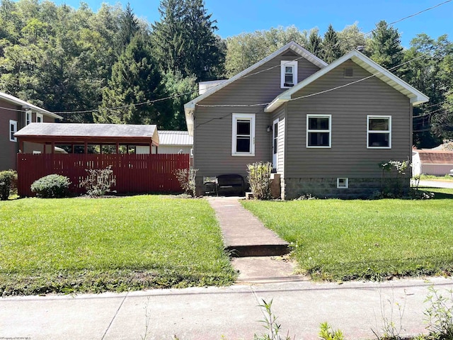 bungalow-style home with a front lawn