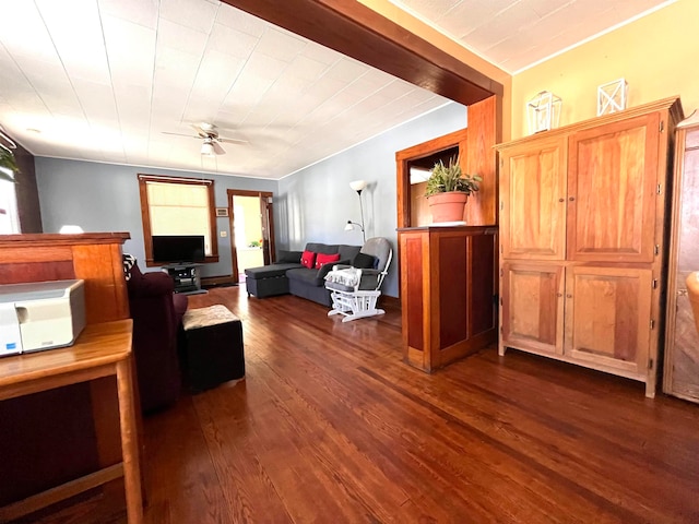 living room featuring dark wood-type flooring and ceiling fan