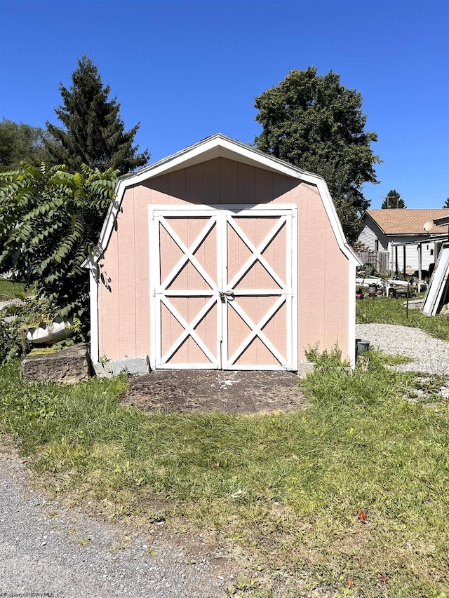 view of outdoor structure featuring a lawn