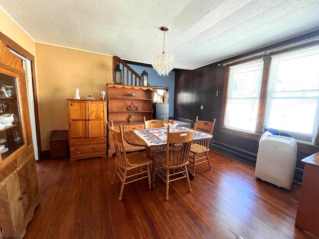 dining area featuring dark wood-type flooring and a chandelier