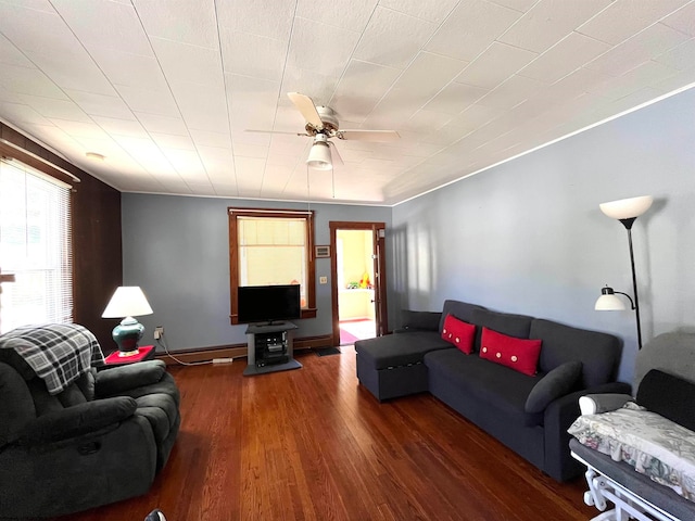 living room featuring dark wood-type flooring and ceiling fan