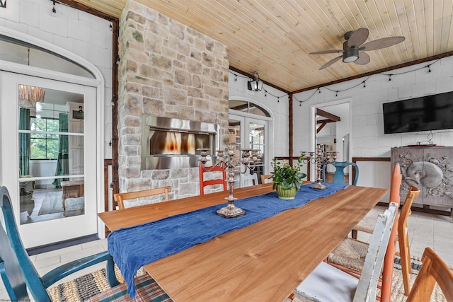 tiled dining area with ceiling fan, wood ceiling, and french doors